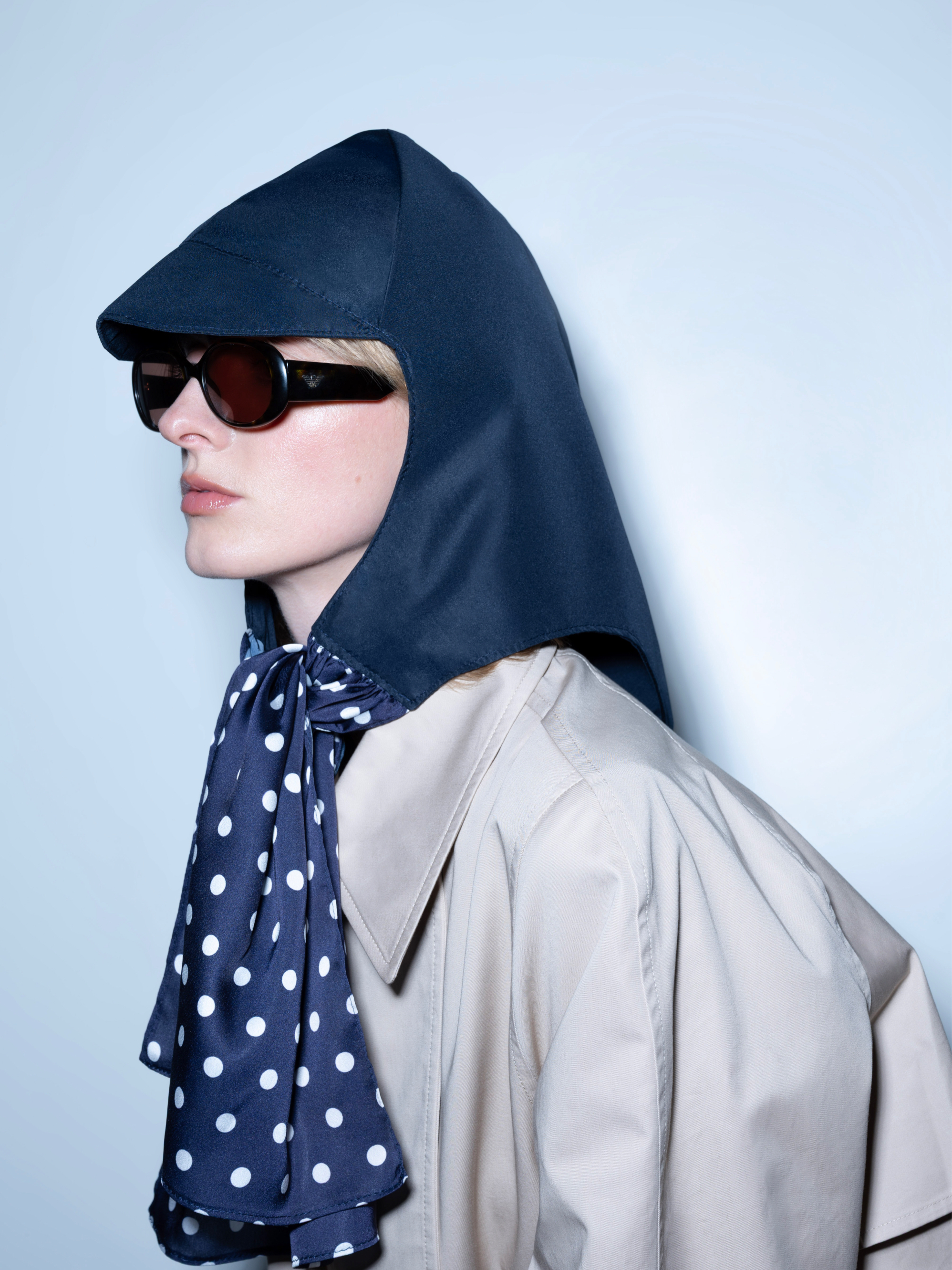La Clochette Midnight Blue Polka Dots with Cap, waterproof headpiece worn by a woman, 3/4 view