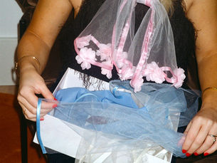 woman holding a handmade headpiece from atelier cappa