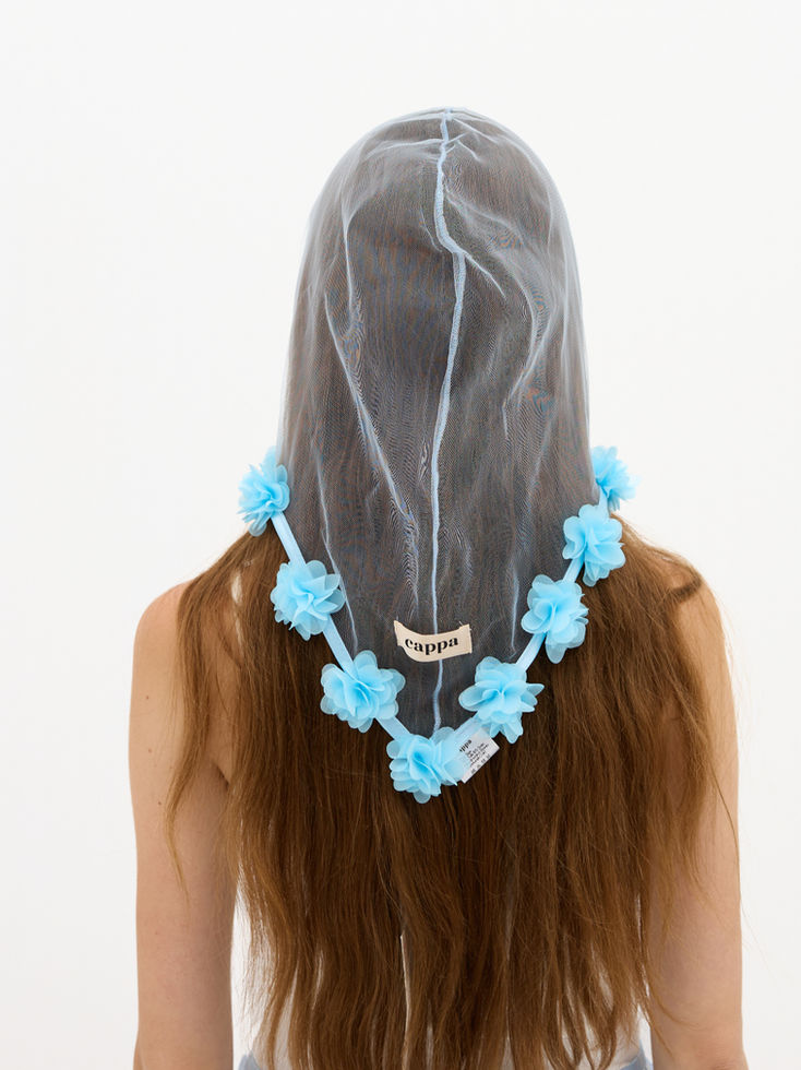 woman wearing baby blue floral headpiece back