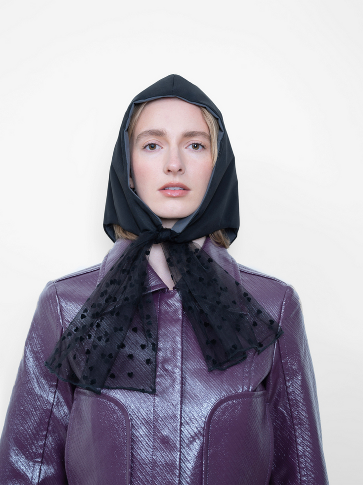 La Clochette Reversible Soft Black/Grey with Hearts, tulle with hearts patterns headpiece worn by a woman, front view