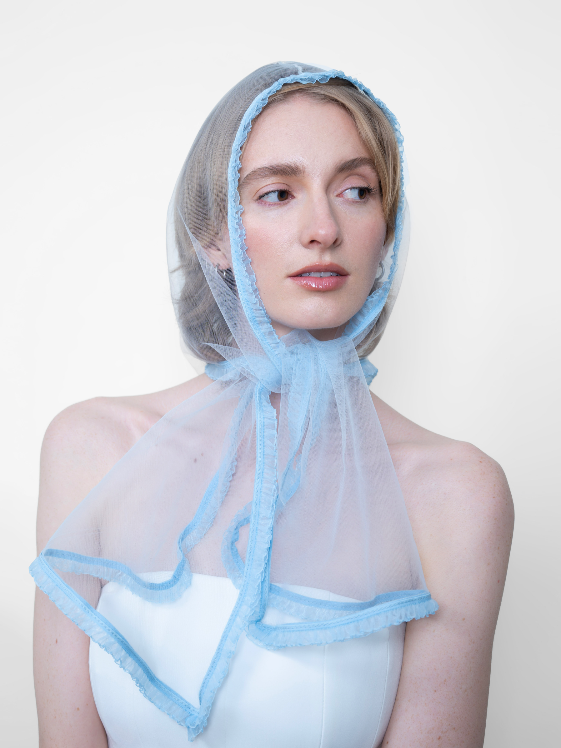 Mademoiselle Seraphina Sky Blue, transparent tulle headpiece worn by a woman, front view