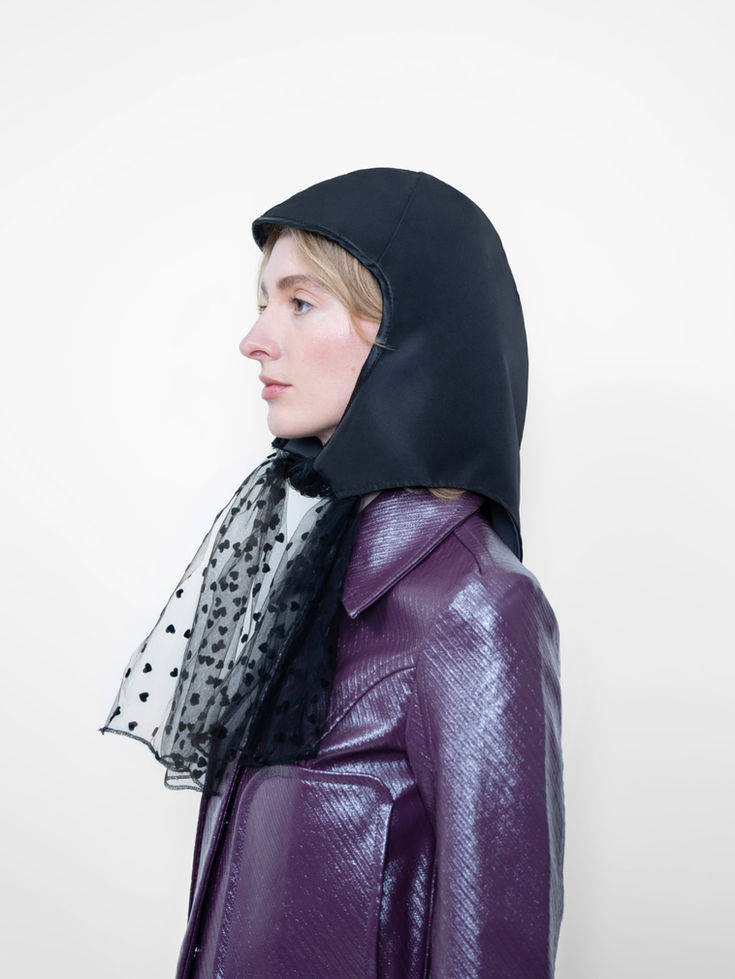 La Clochette Reversible Soft Black/Grey with Hearts, tulle with hearts patterns headpiece worn by a woman, 3/4 view