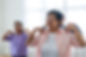 Aging adult woman participating in an exercise class for seniors.