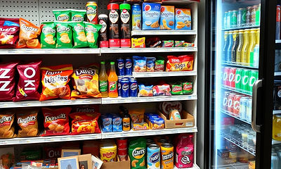 a photo of candies, and beverages in a convenience store. Make it as realistic as possible