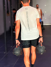 One of our members doing farmers carry and wearing our SK Tshirt