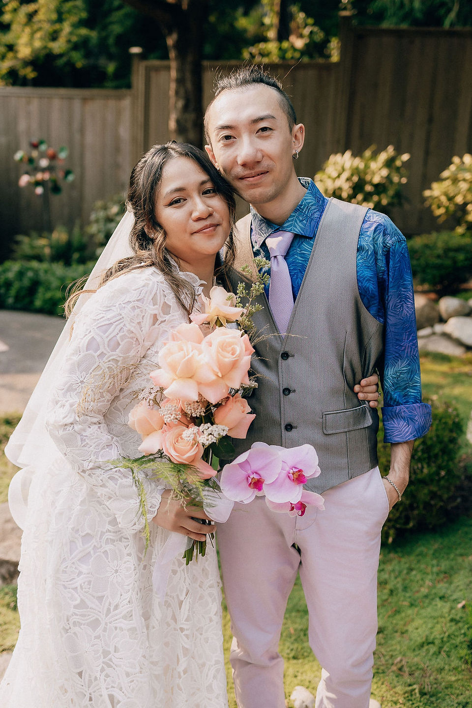 Bride and wedding dress designer posing together