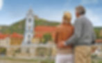 A couple enjoys a peaceful moment while taking in the historic beauty of a riverside town during a European river cruise.
