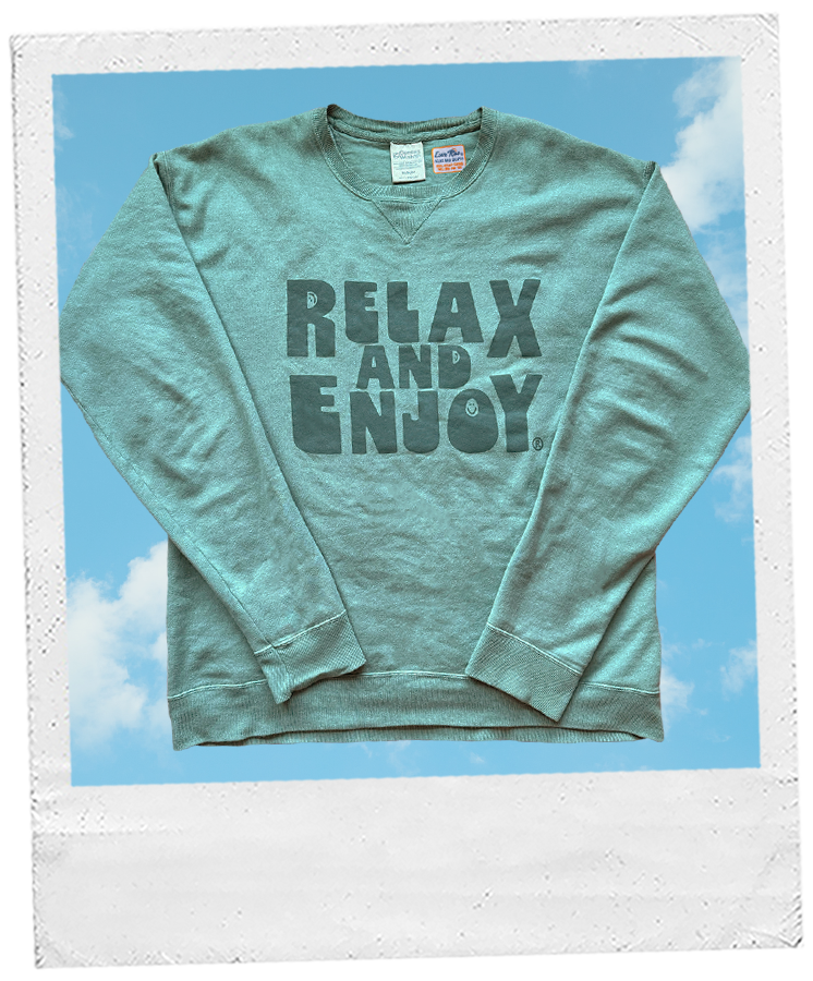 Thumbnail: green crewneck sweatshirt with 3 smiley faces and block letters writing "relax and enjoy" in green screen print