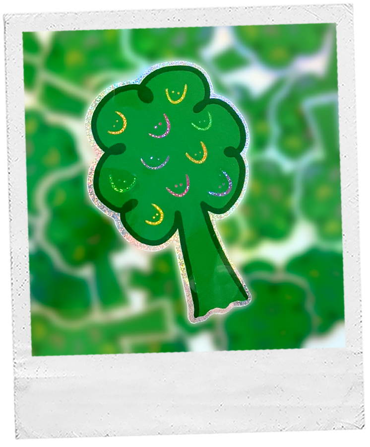 dark green tree sticker decorated with colorful smiley faces. The light reflects off the smiley faces, making them sparkle