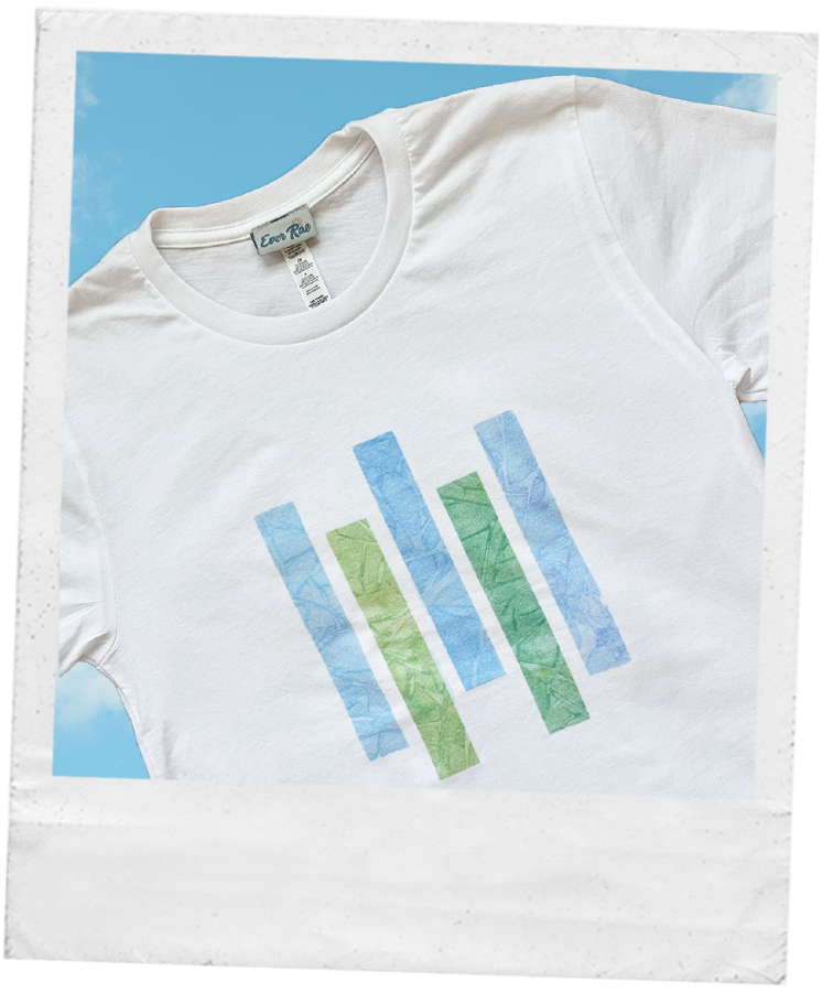 Thumbnail: white t-shirt with geometric design of blue and green watercolor artwork. design represents the growth we experience in life