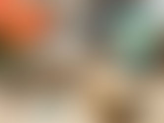 Lotion Candles on a wooden table next to lip balm and peach tulips