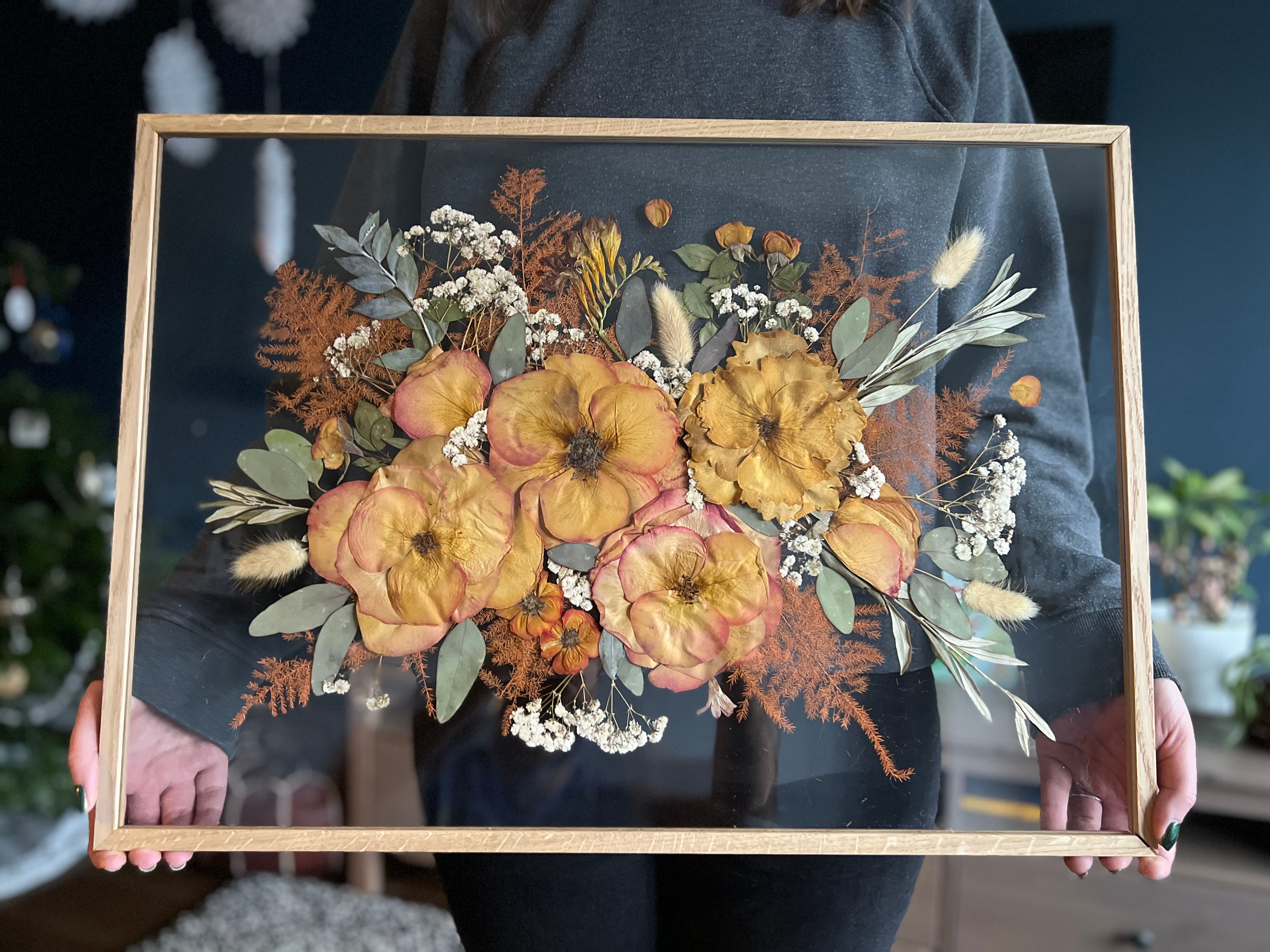 Woman holding double sided flower press frame