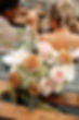 Bridal bouquet of roses and hydrangeas sat on the boot of a car