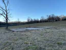 Foundation being laid for a new barn construction, showcasing the start of a robust agricultural structure.