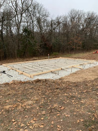 Foundation being laid for a new barn construction, showcasing the start of a robust agricultural structure.