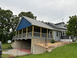 Construction of a home addition underway in Mountain Grove, emphasizing a stylish and functional porch.