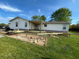 View of a partially completed deck, featuring framework and railings, ready for final touches and finishing.