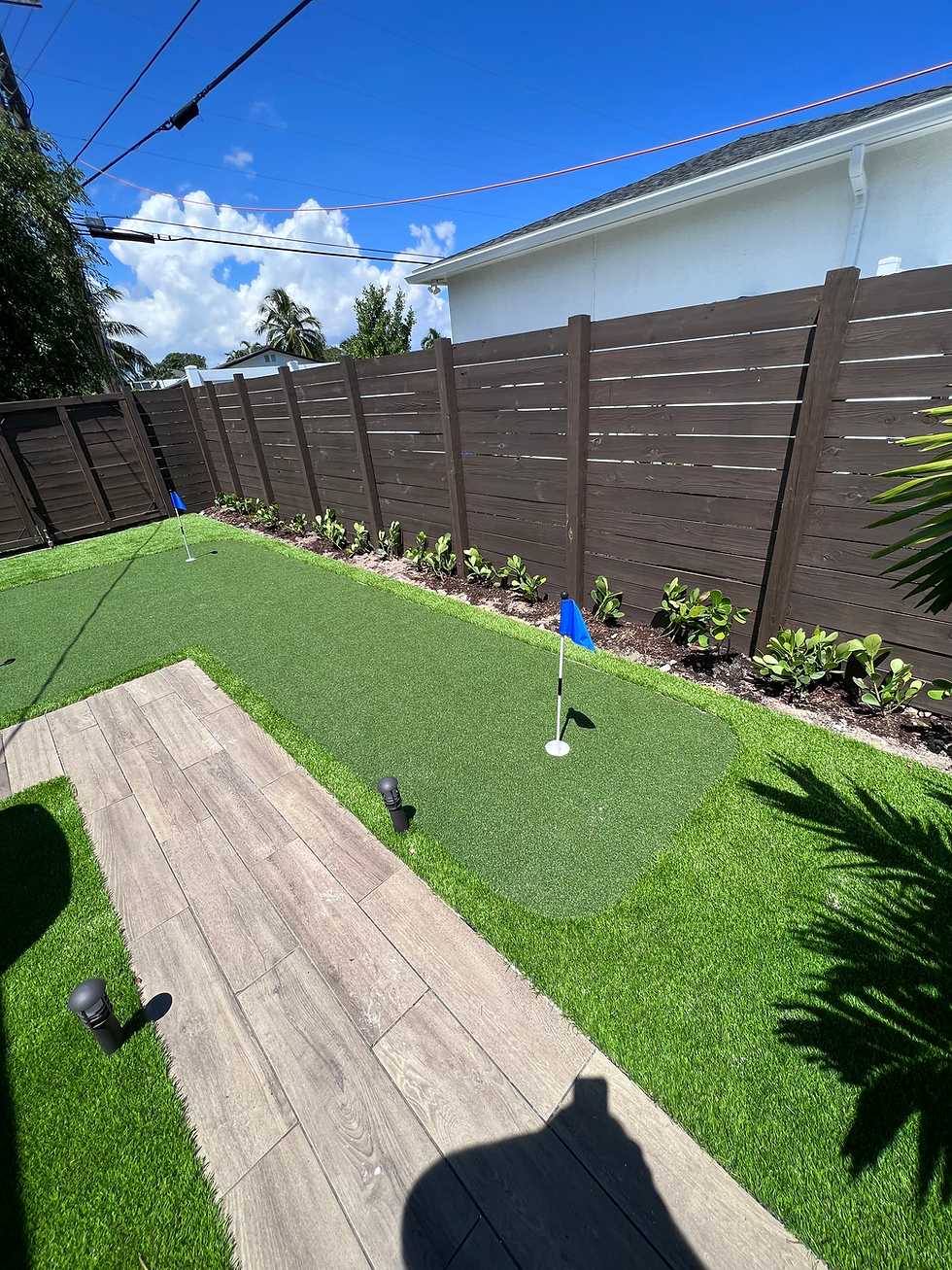 Backyard remodel featuring a turf putting green and new fence.