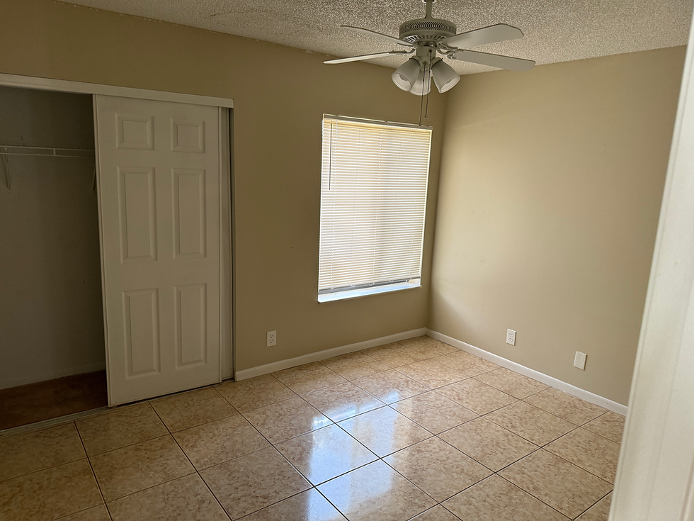 Bedroom remodel with tiled floor and ceiling fan.