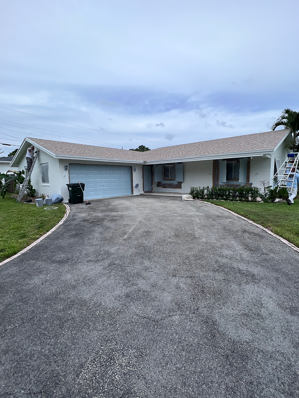 Exterior home remodel showing a fresh white paint job.