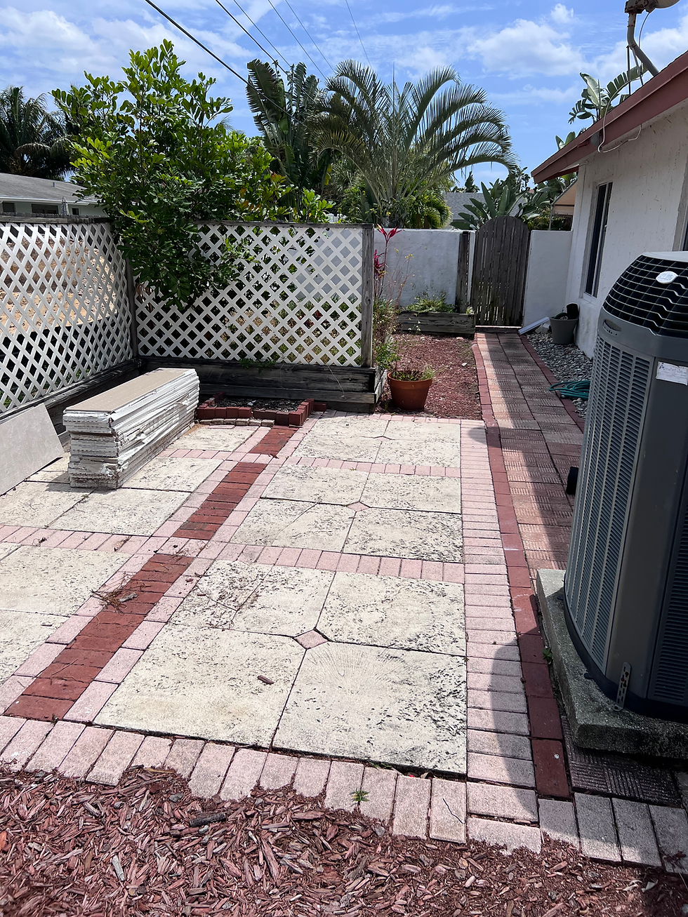 Patio remodel with stone pavers and brick border.