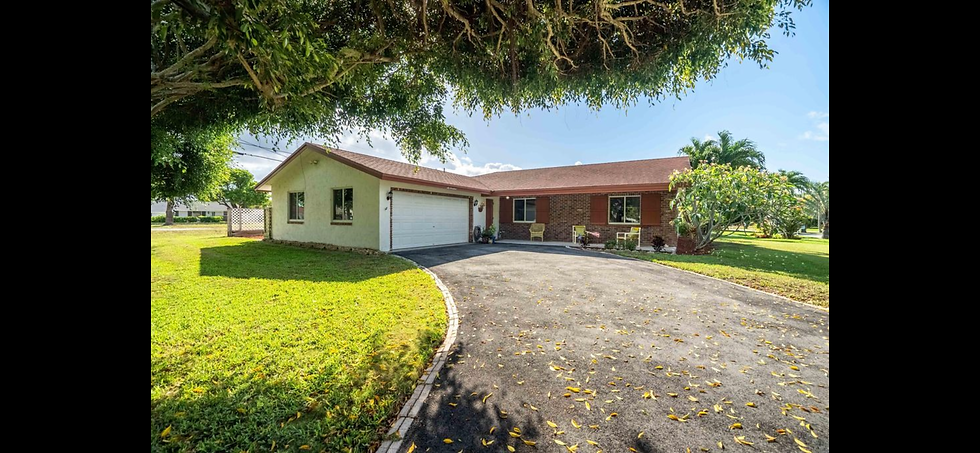 Outdated home exterior remodel with asphalt driveway.