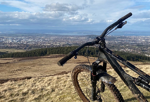 Mountain bike overlooking Edinburgh, Scotland from the Pentland Hills.