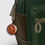 Thumbnail: Green backpack with orange emblem zipper pull