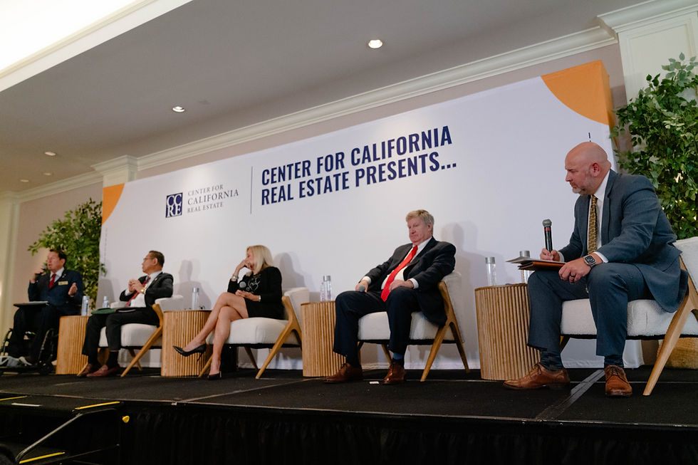 Four panelists and one moderator on a stage with a white Center for California Real Estate backdrop