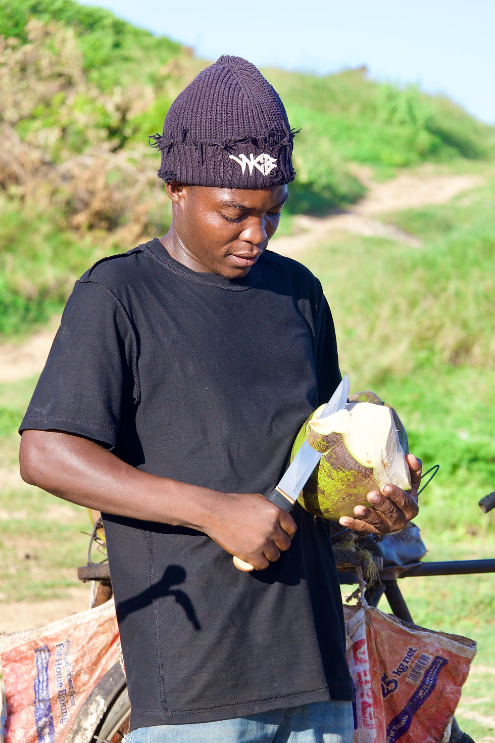 Mr. Hamisi photo showing his coconut trimming expertise.