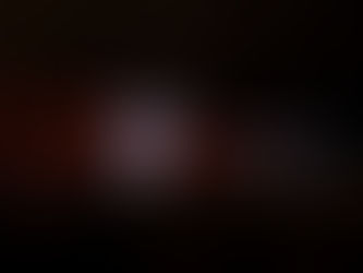 Singer on stage raises arms, wearing a cap and vest, accompanied by a guitarist. Colorful stage lights illuminate the cheering crowd.