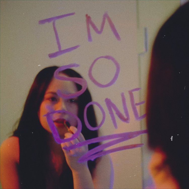Single artwork for Filipina-Canadian indie pop artist and actress Jaenna Cali's brand new single, "i'm so done." The picture depicts Jaenna in the mirror putting on make up, with the song title written on the mirror in purple lipstick.