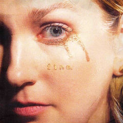 Close-up of a woman's face with a tear and the word fine in gold on her cheek.