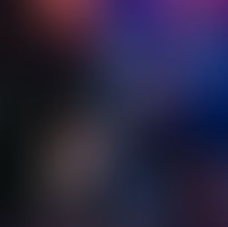 Guitarist plays passionately under purple stage lights with a drummer in the background. Dark curtains and a Yamaha drum set visible.