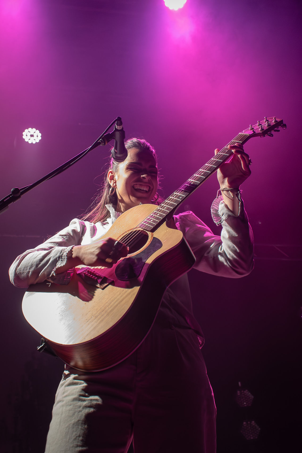 Steph Strings performing with just an acoustic guitar and microphone in Winnipeg.