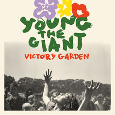 Monochrome scene with a joyful crowd. Person with raised arms. "Young the Giant" and "Victory Garden" in colorful, bold text above.