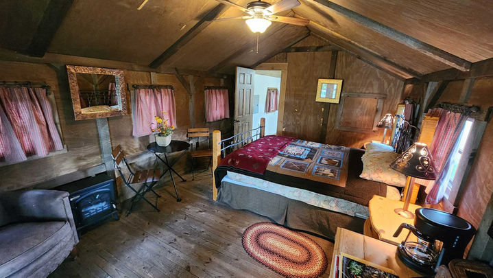 Cozy rustic cabin bedroom interior at Hangman’s Guest Ranch