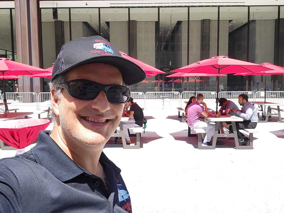 Event staff providing on-site event management in an outdoor courtyard with guest seating and umbrellas.