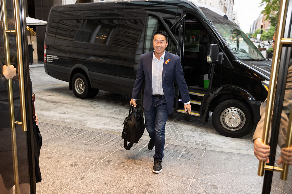 Executive stepping out of a black Sprinter van onto a cobbled hotel drive at Hilton's 2023 Leadership Group meeting
