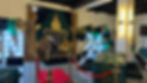Green and gold graduation party setup with balloon arch, throne chair and red carpet at Fulton West event venue.