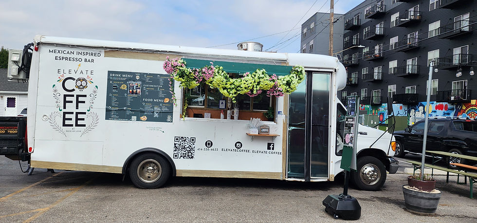 White coffee food truck with floral arrangements over the counter