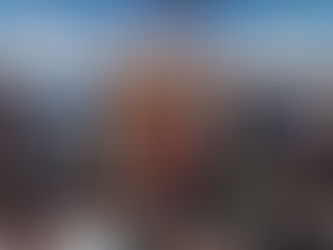 Four smiling people stand in front of a Skydeck Chicago booth with promotional materials and photos. Skydeck and The Ledge text visible.