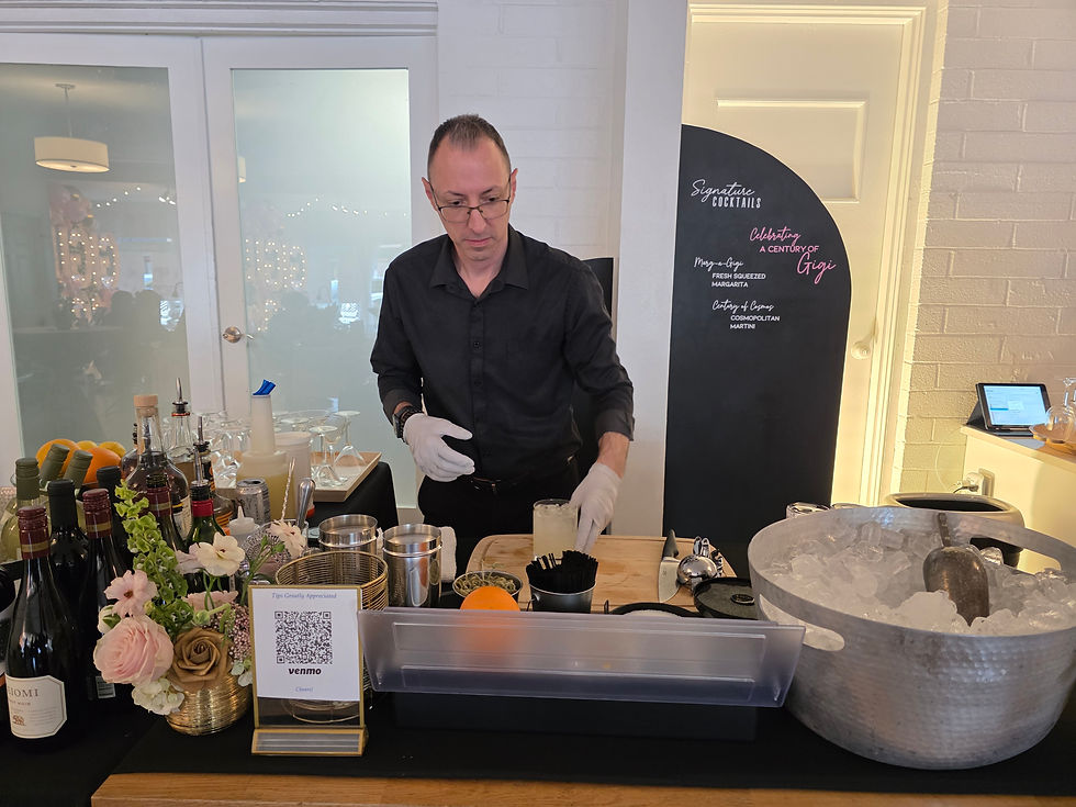 Professional bartender making drinks at a signature cocktail bar at an event