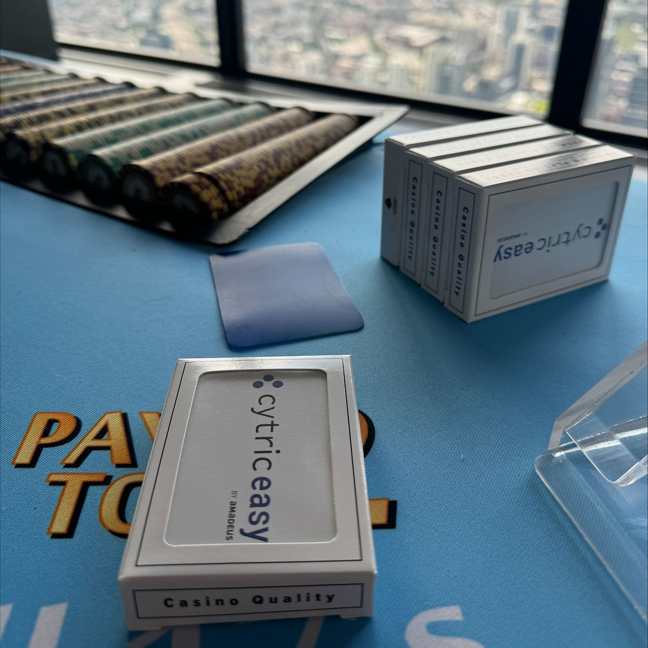 Customized playing cards with Cytric Easy branding displayed at a corporate casino night by Bright Light Events
