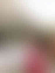 Guest in a bold pink maxi dress selecting a glass of wine at an outdoor bridal shower cocktail hour.