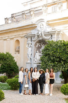 A group of tourists posing in front of Palazzo Shedir in Rome