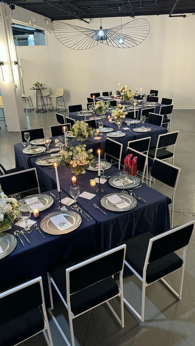 Candlelit navy dinner tables arranged for a private gathering at our Chicago event venue.
