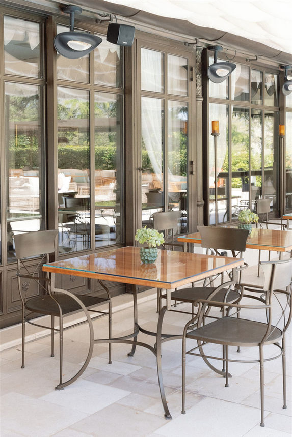 Outdoor terrace seating with café tables and garden views at Villa Cora, an elegant Italy wedding venue.