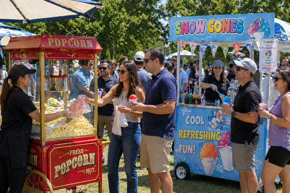 Guests enjoying popcorn and snow cones at an outdoor summer event food station by Bright Light Events