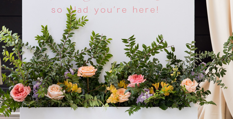 Welcome sign and blooms